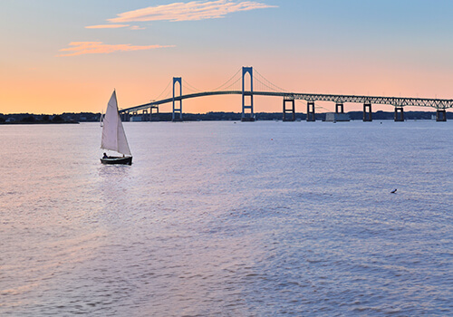 newport-ri-bridge-sailboat-ascrop Sailboat in front of Newport, RI bridge