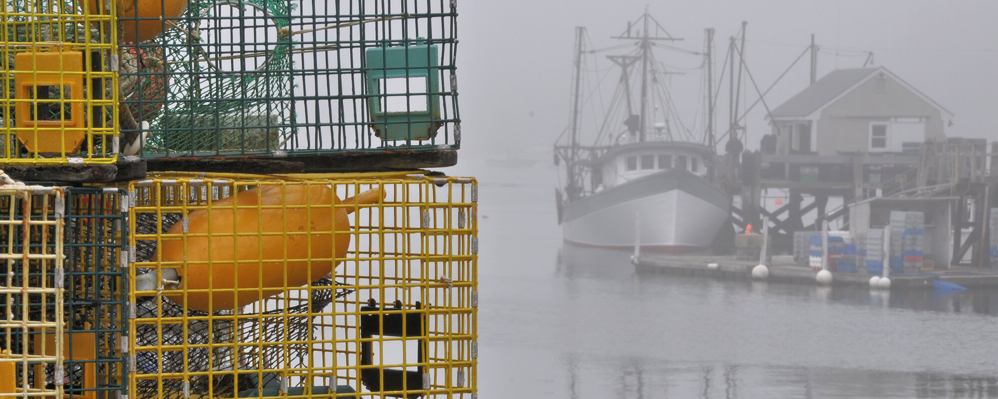 lobster traps stacked on dock in Port Clyde, Maine